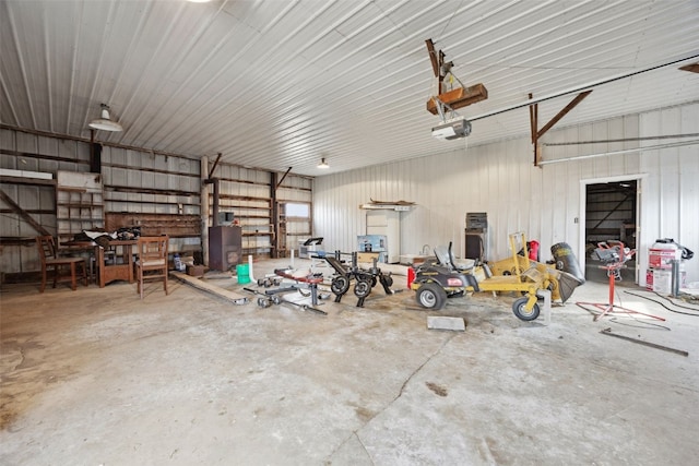 garage with a garage door opener and metal wall