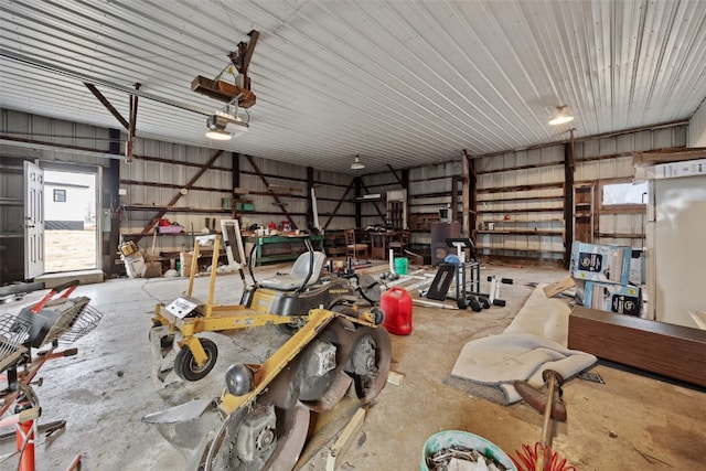 garage with a garage door opener and metal wall