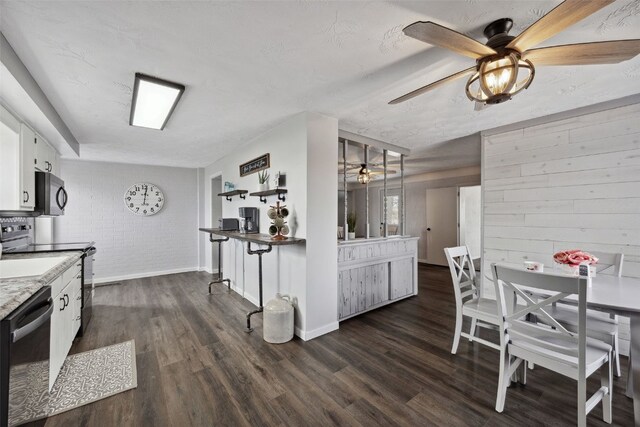 kitchen featuring white cabinets, dishwasher, dark wood-type flooring, and black microwave