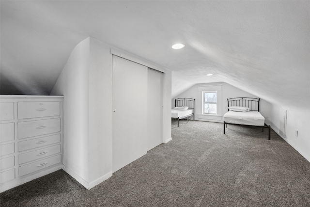 unfurnished bedroom with carpet and vaulted ceiling