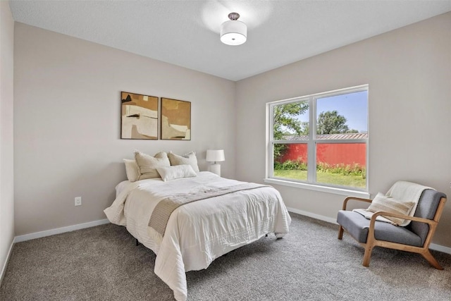 bedroom featuring baseboards and carpet floors