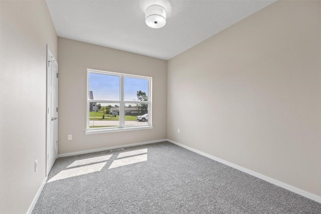 carpeted empty room with baseboards