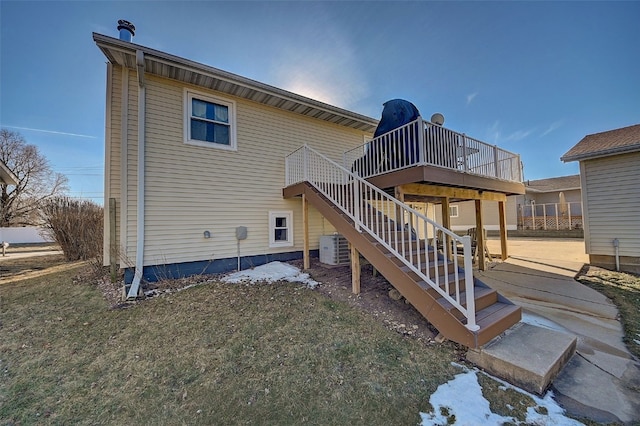 rear view of house with stairway, a lawn, central AC, and a wooden deck