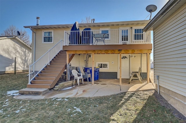 rear view of house featuring a patio area, stairway, and a deck