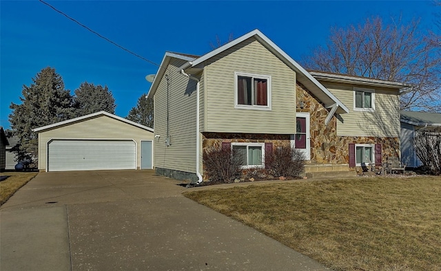 split foyer home with a garage, stone siding, an outdoor structure, and a front lawn