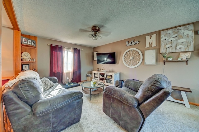 carpeted living room with baseboards, a textured ceiling, and ceiling fan