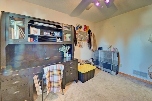 carpeted office space with a ceiling fan, baseboards, and visible vents