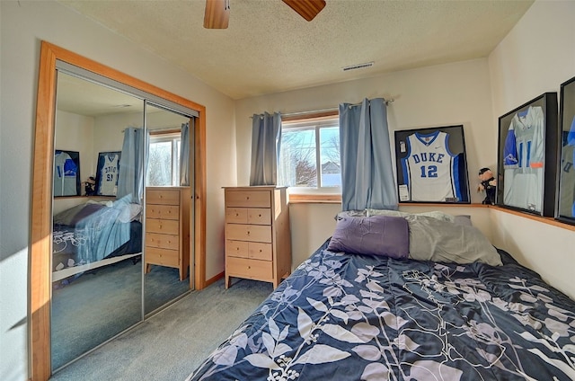 bedroom with a closet, visible vents, multiple windows, and carpet floors