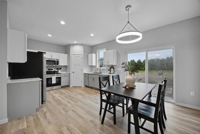 dining space with recessed lighting, baseboards, and light wood-style floors