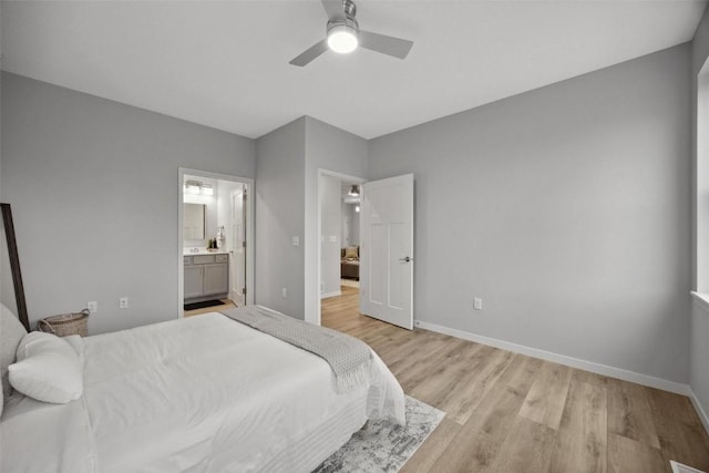 bedroom with ensuite bathroom, baseboards, light wood finished floors, and ceiling fan