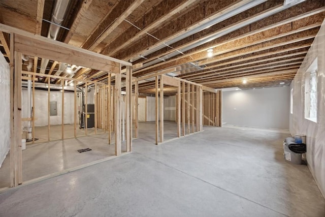 basement with electric panel and heating unit