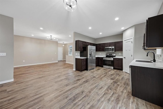 4193 Justified Dr, Marion, IA 52302 - kitchen with appliances with stainless steel finishes, open floor plan, a sink, recessed lighting, and light wood finished floors