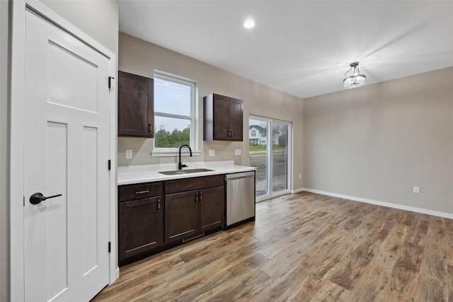 4193 Justified Dr, Marion, IA 52302 - kitchen featuring dishwasher, a sink, light countertops, dark brown cabinets, and light wood-style floors