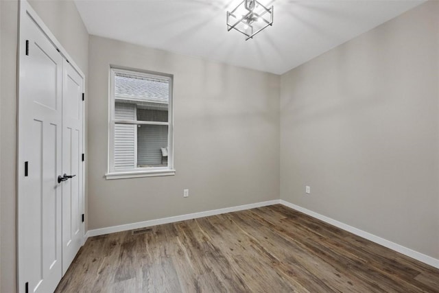 4193 Justified Dr, Marion, IA 52302 - unfurnished bedroom with wood finished floors, baseboards, and a closet