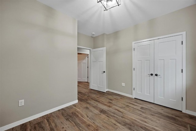 4193 Justified Dr, Marion, IA 52302 - unfurnished bedroom with baseboards, wood finished floors, and a closet