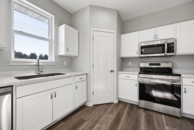 4209 Justified Dr, Marion, IA 52302 - kitchen with stainless steel appliances, a sink, white cabinetry, and light countertops