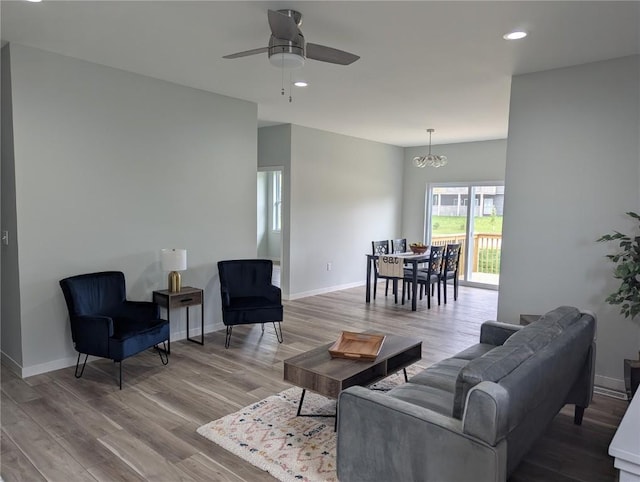 4209 Justified Dr, Marion, IA 52302 - living area with wood finished floors, ceiling fan, recessed lighting, baseboards, and a chandelier