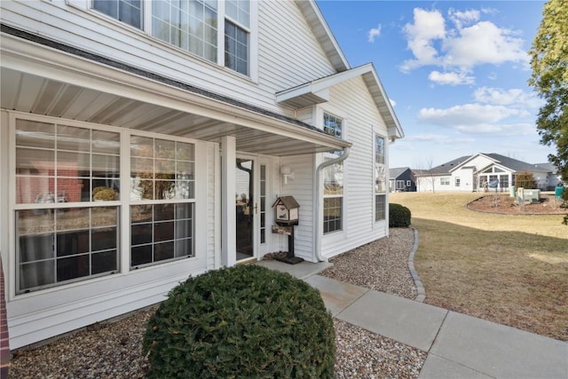 entrance to property featuring a lawn