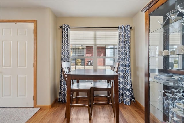 dining area with wood finished floors and baseboards