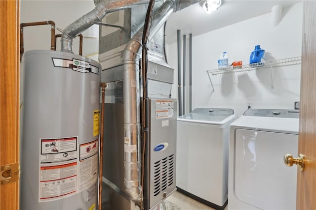 laundry area with washer and dryer, laundry area, and water heater