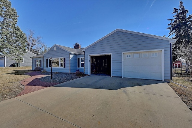 ranch-style home with a garage and driveway