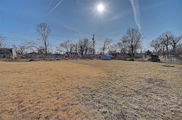 view of yard featuring a storage shed and an outdoor structure