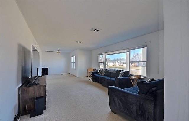 living room featuring visible vents and light colored carpet