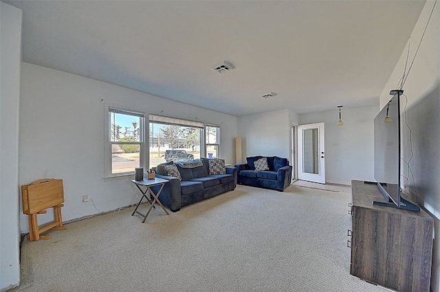 carpeted living area with visible vents