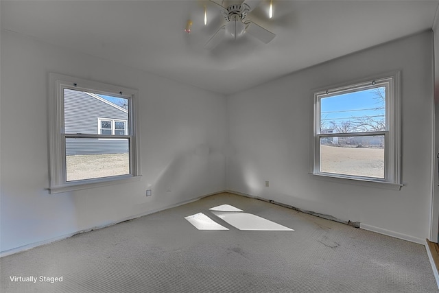 unfurnished room featuring carpet, a ceiling fan, and a wealth of natural light