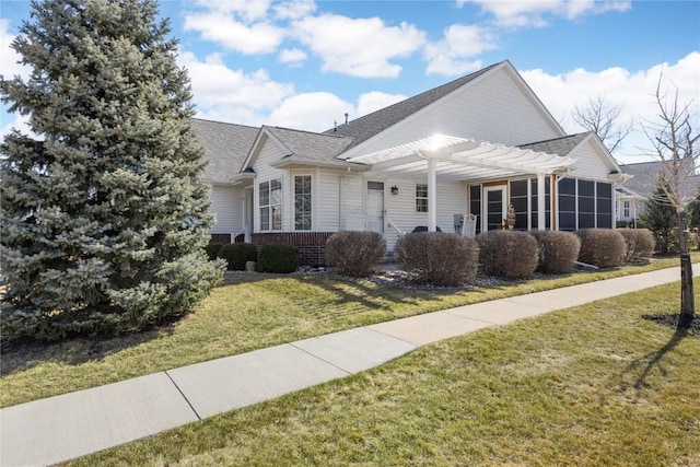 view of front of home featuring a front yard, brick siding, a pergola, and roof with shingles