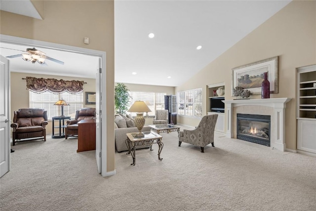 living room featuring a fireplace, carpet, and high vaulted ceiling