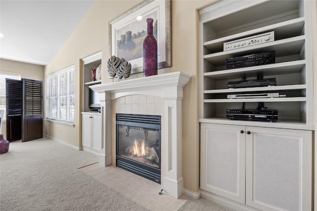 living area with baseboards, light carpet, vaulted ceiling, and a tile fireplace