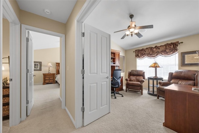 office with baseboards, light carpet, lofted ceiling, and ceiling fan