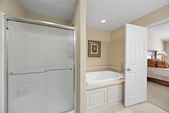 ensuite bathroom with recessed lighting, a stall shower, ensuite bathroom, a garden tub, and tile patterned floors