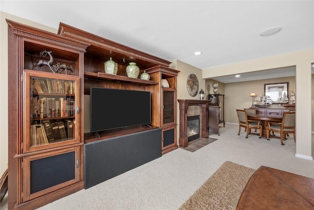 living area featuring carpet flooring, recessed lighting, a tile fireplace, and baseboards