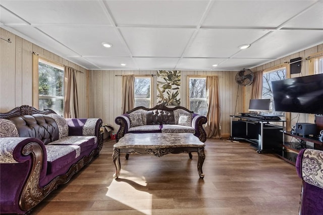 living area with plenty of natural light, coffered ceiling, and wood finished floors