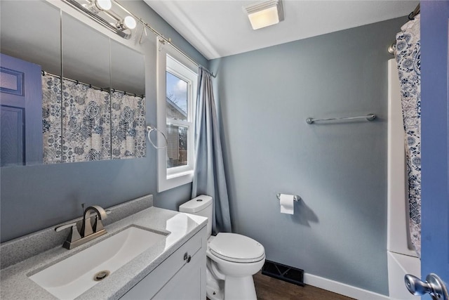 bathroom featuring visible vents, baseboards, toilet, and vanity