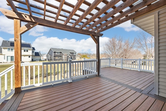 wooden terrace with a residential view and a pergola