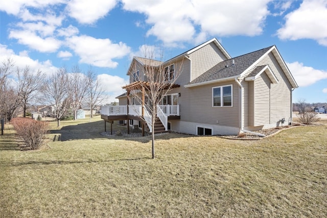 back of property featuring stairway, a lawn, a deck, and roof with shingles