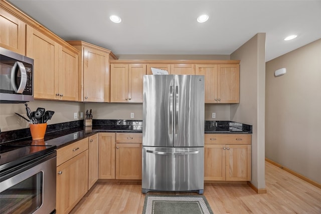 kitchen with light brown cabinets, recessed lighting, appliances with stainless steel finishes, and light wood-style floors