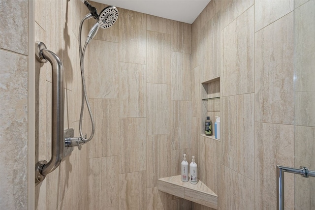 bathroom with a tile shower