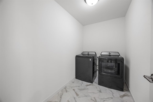 laundry area with laundry area, independent washer and dryer, marble finish floor, and baseboards