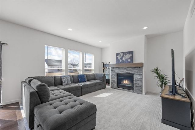 carpeted living room with recessed lighting, baseboards, and a fireplace