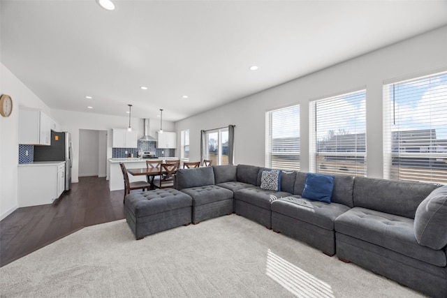 living area featuring dark wood-type flooring and recessed lighting