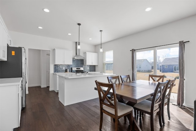 dining area with dark wood finished floors, recessed lighting, and baseboards