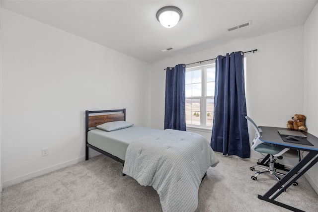 carpeted bedroom with visible vents and baseboards