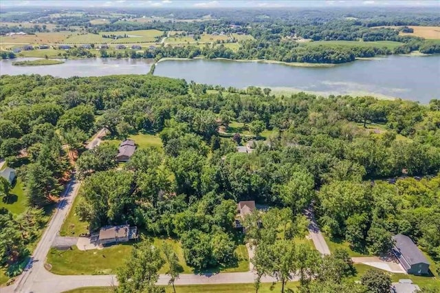 drone / aerial view featuring a forest view and a water view