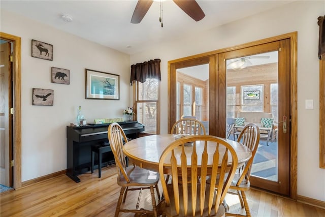 dining space with light wood-style flooring, baseboards, and ceiling fan