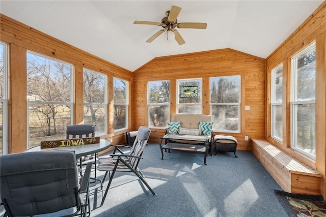 sunroom / solarium with lofted ceiling and a ceiling fan