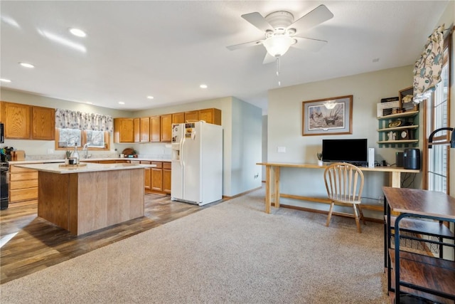 kitchen with recessed lighting, ceiling fan, light countertops, white refrigerator with ice dispenser, and carpet flooring